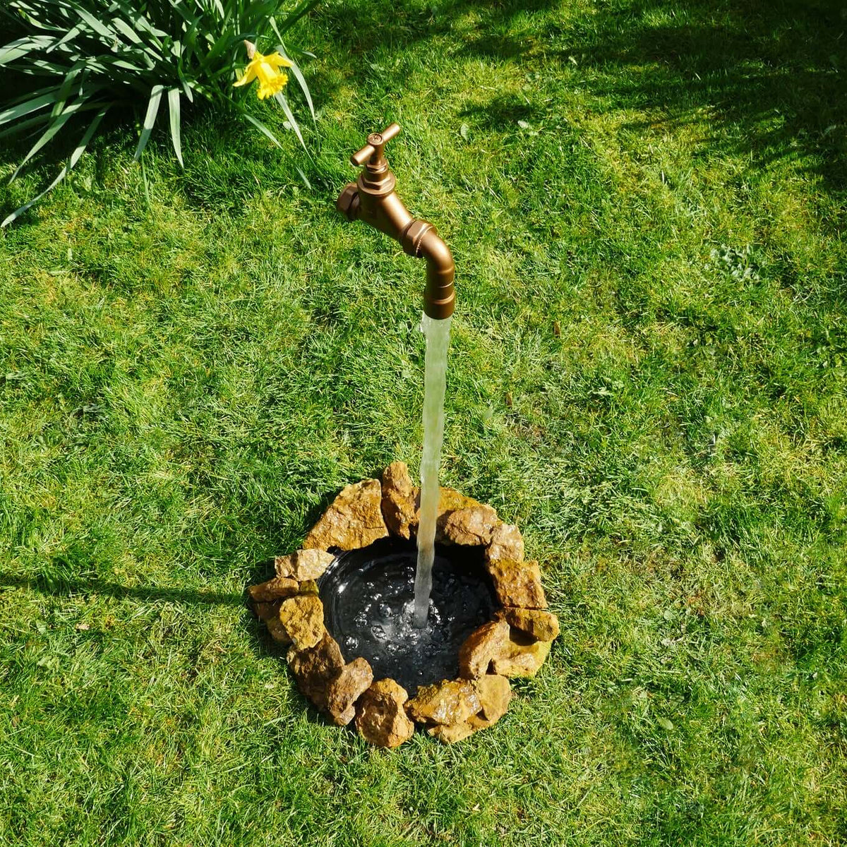 A floating Tap Water Feature buried in the ground to appear to float from the. ground